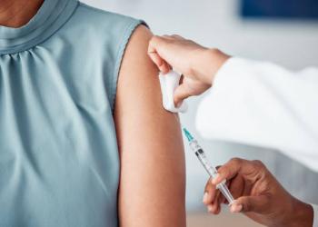 Hands, medical and doctor with patient for vaccine in a clinic for healthcare treatment for prevention. Closeup of a nurse doing a vaccination injection with a needle syringe in a medicare hospital.