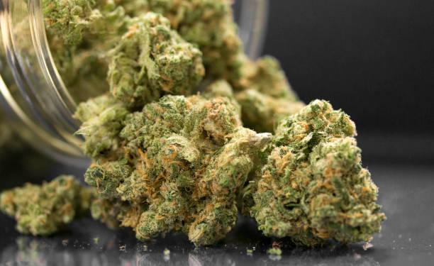 Close Up Of Cannabis Flowers In Jar And Table